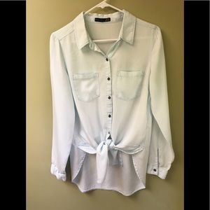Long sleeved light blue shirt/blouse